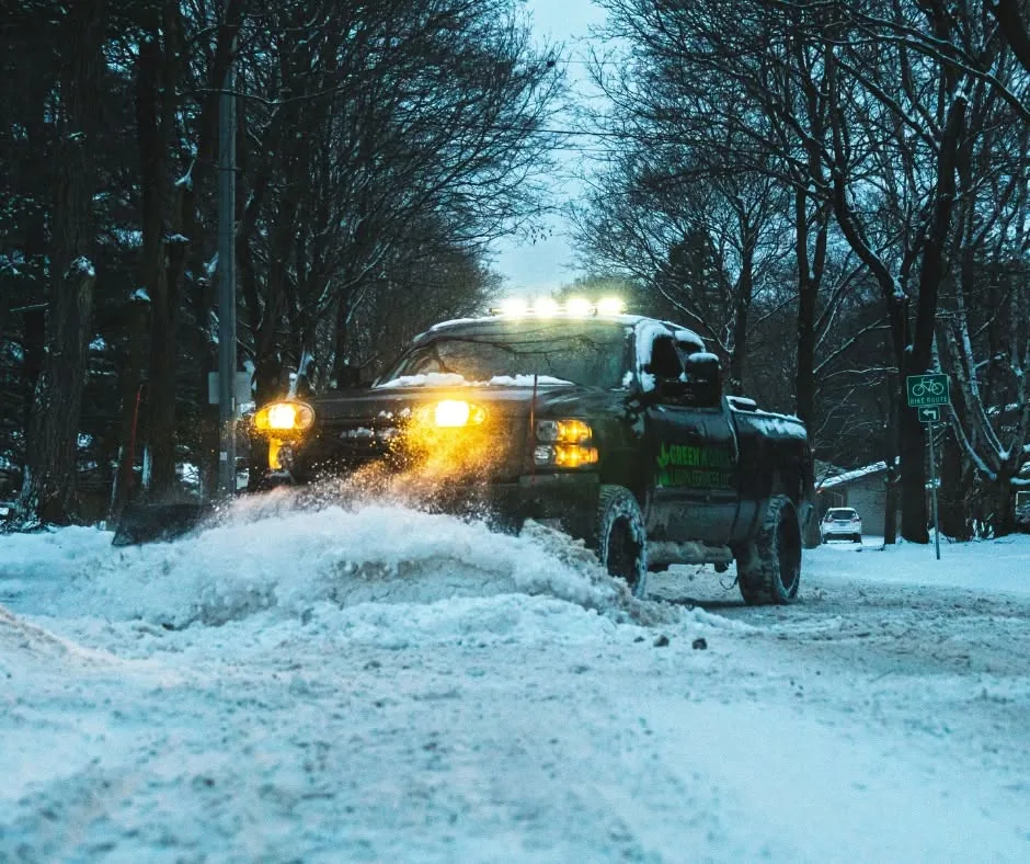 Greenworks snow plow truck working at night