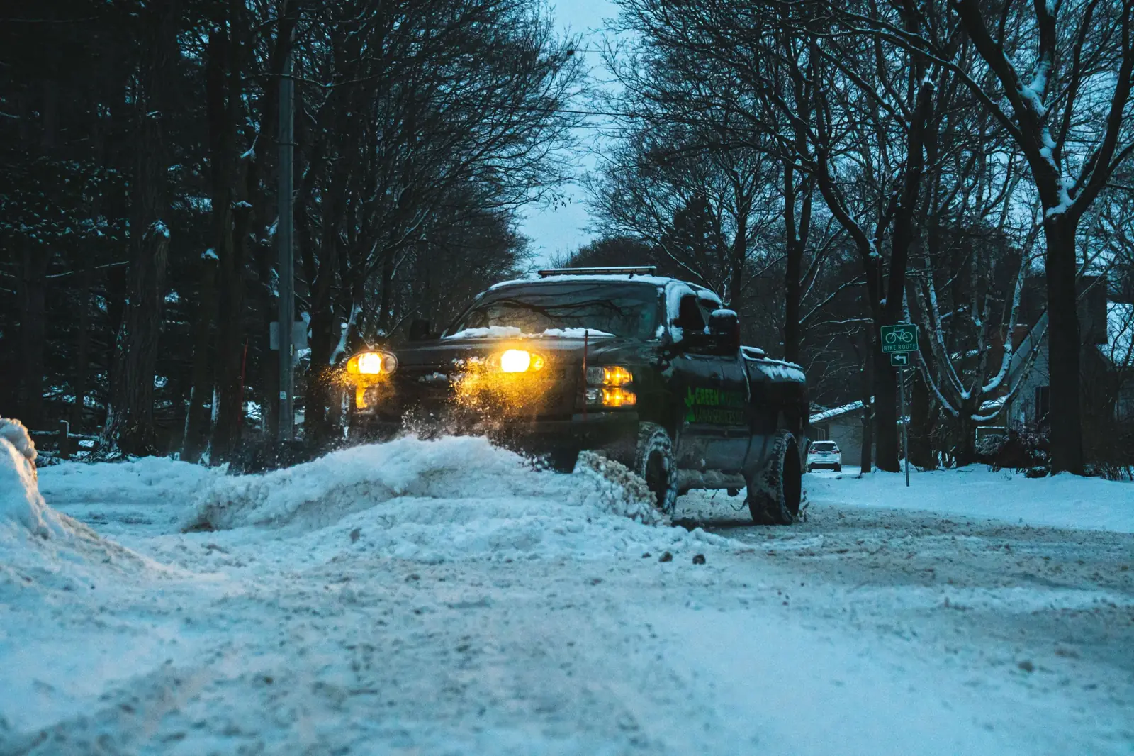 Greenworks plow truck clearing a residential street in winter
