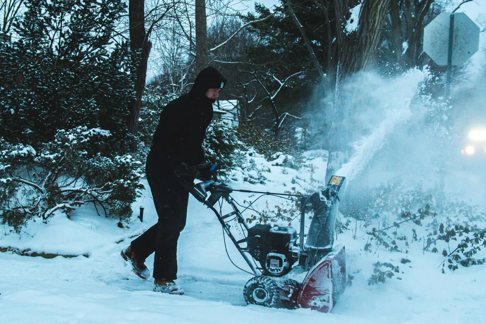 Greenworks plow truck moving snow along a residential drive
